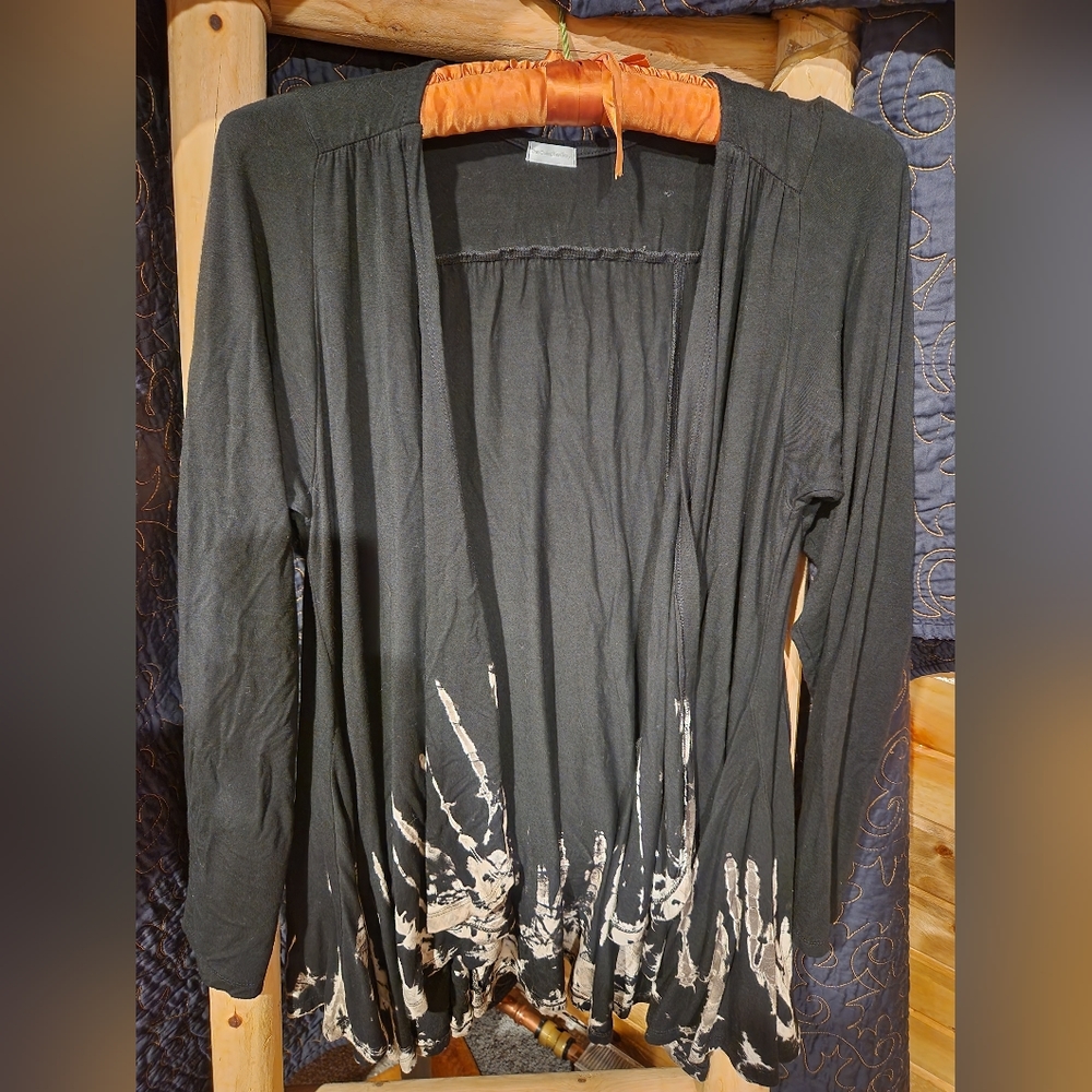 Black cardigan with tan/brown detailing on the bottom of item